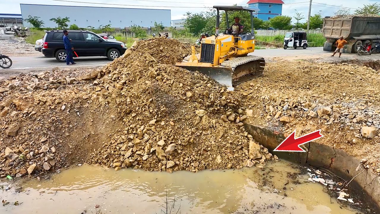 Please Be careful of the NEW road expansion by KOMATSU Dozer pushing rocks with a 25-ton rock truck
