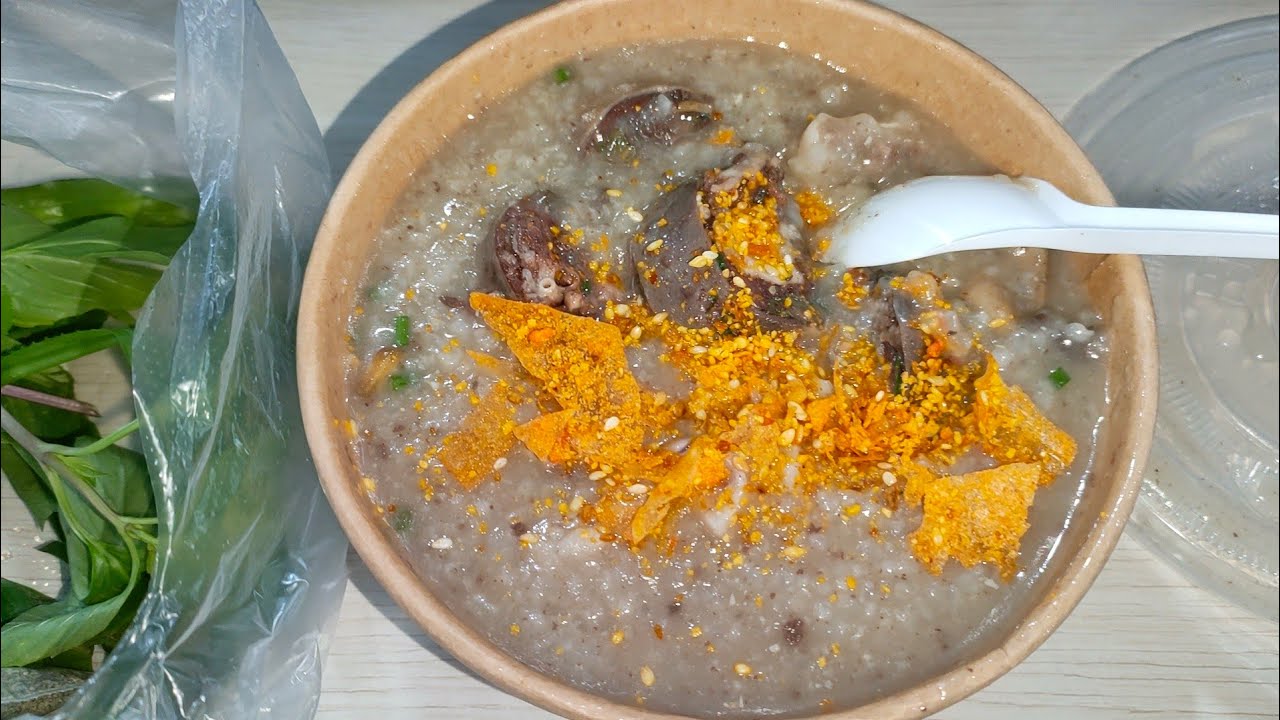 Delicious dinner with porridge, boiled pig's innards, green vegetables, in Hanoi, Vietnam