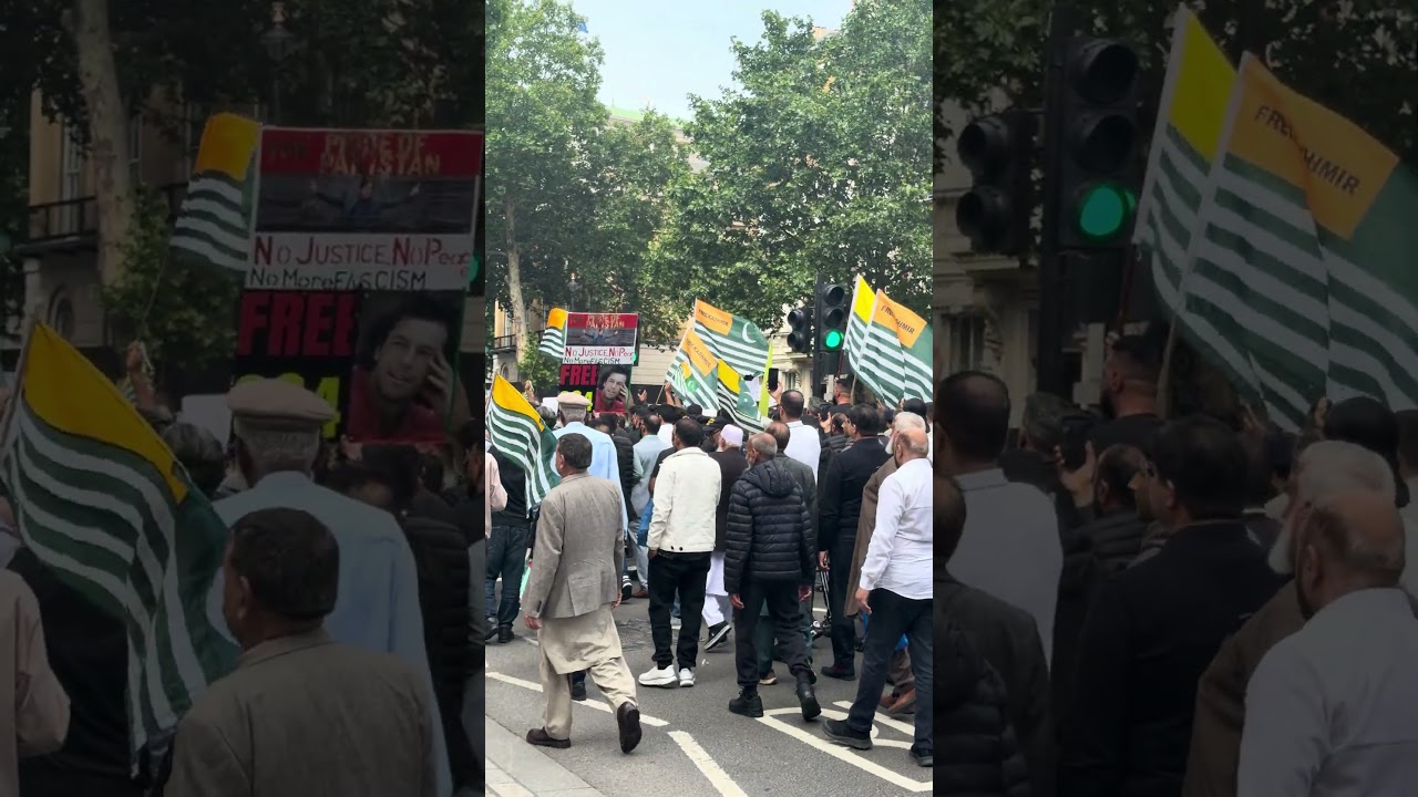Free Kashmir protesters march through central London Whitehall Road past Downing Street