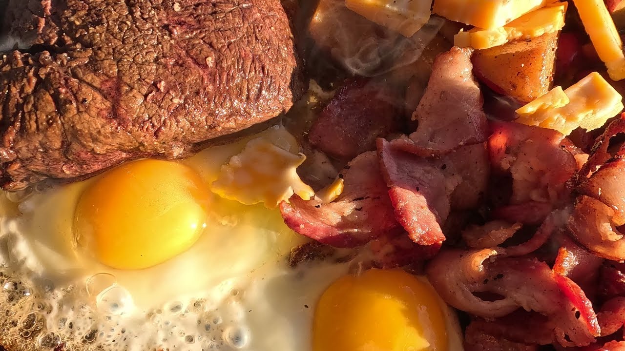 Builiding a rock fire pit. Cooking Steak,Bacon, Eggs and Bread from scratch. PT4