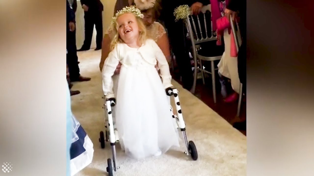 4-year-old daughter walks for the first time at mother's wedding.