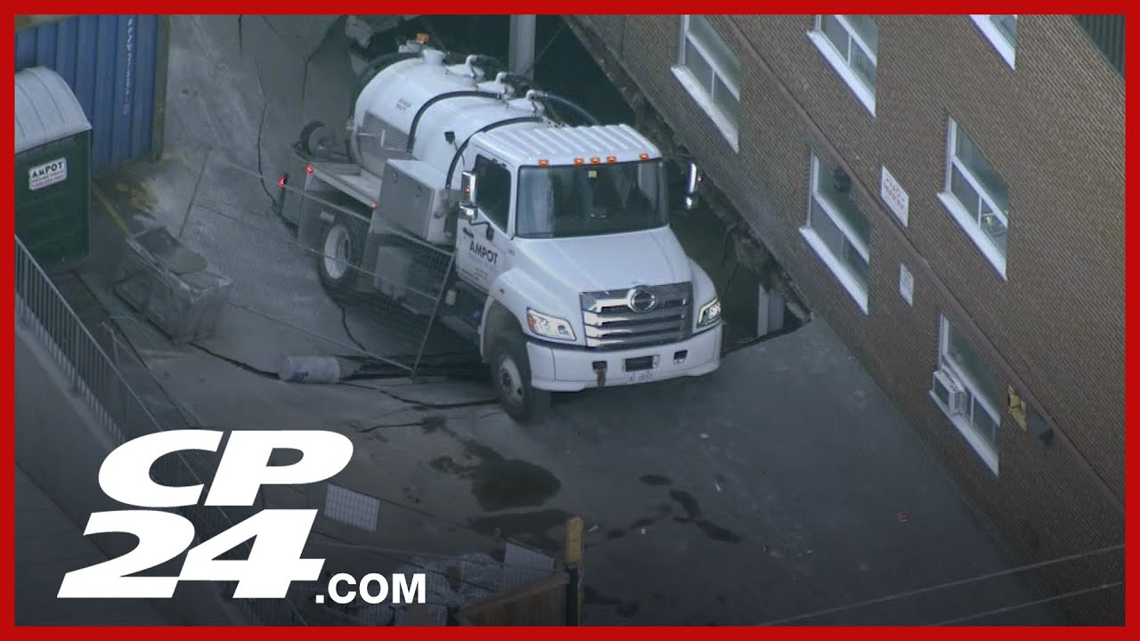 Fire crews working to remove truck stuck in a sinkhole at Etobicoke apartment building