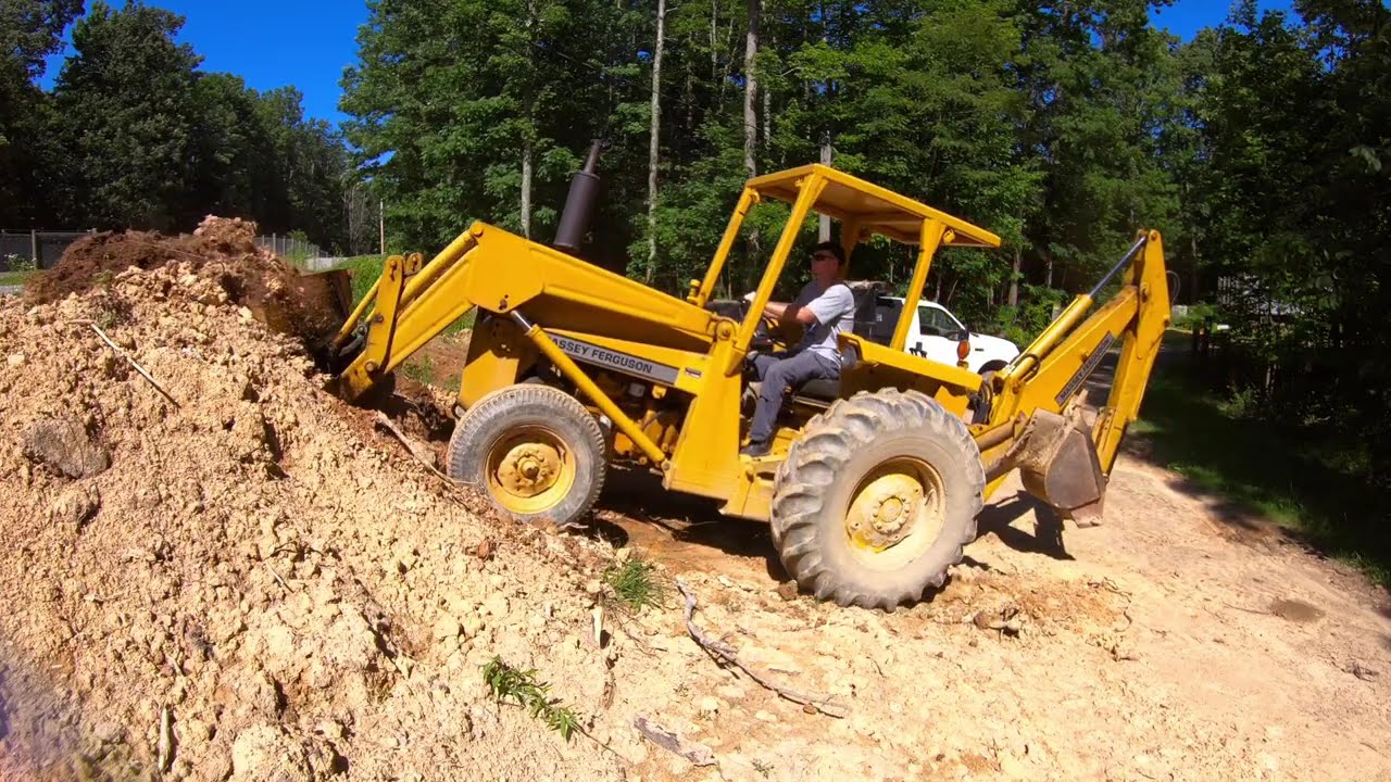 Grading a Hillside, Digging Ditches, Installing a Culvert Pipe, and Graveling a Road
