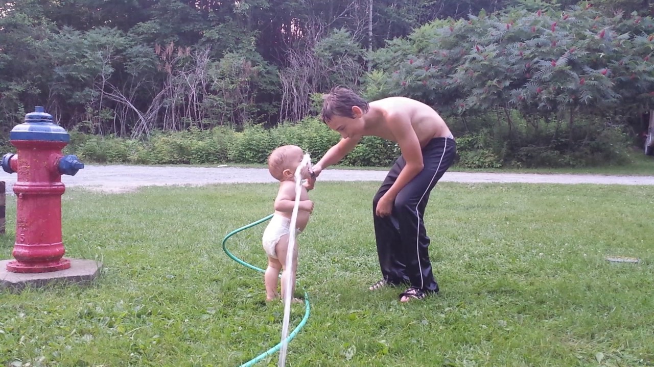 Boys playing with the hose.