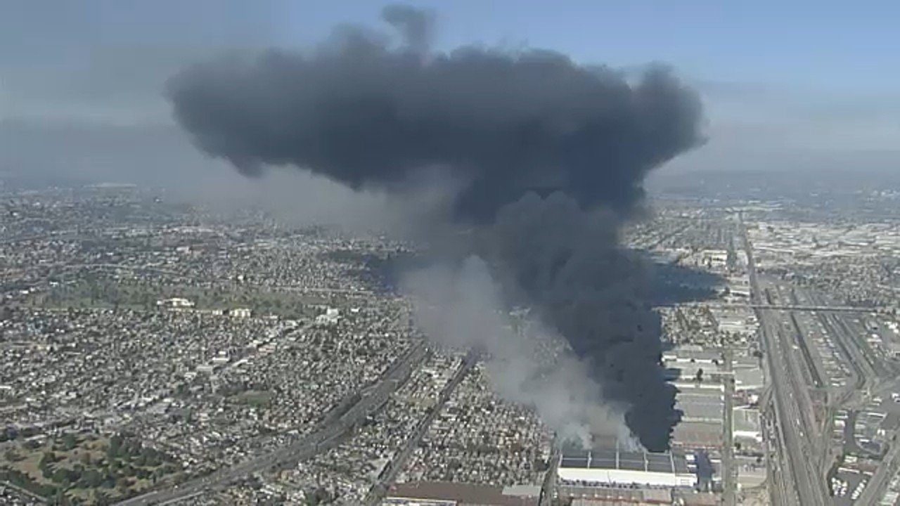 Crews battle smoldering Boyle Heights warehouse fire as flare-ups continue, AIR7 overhead