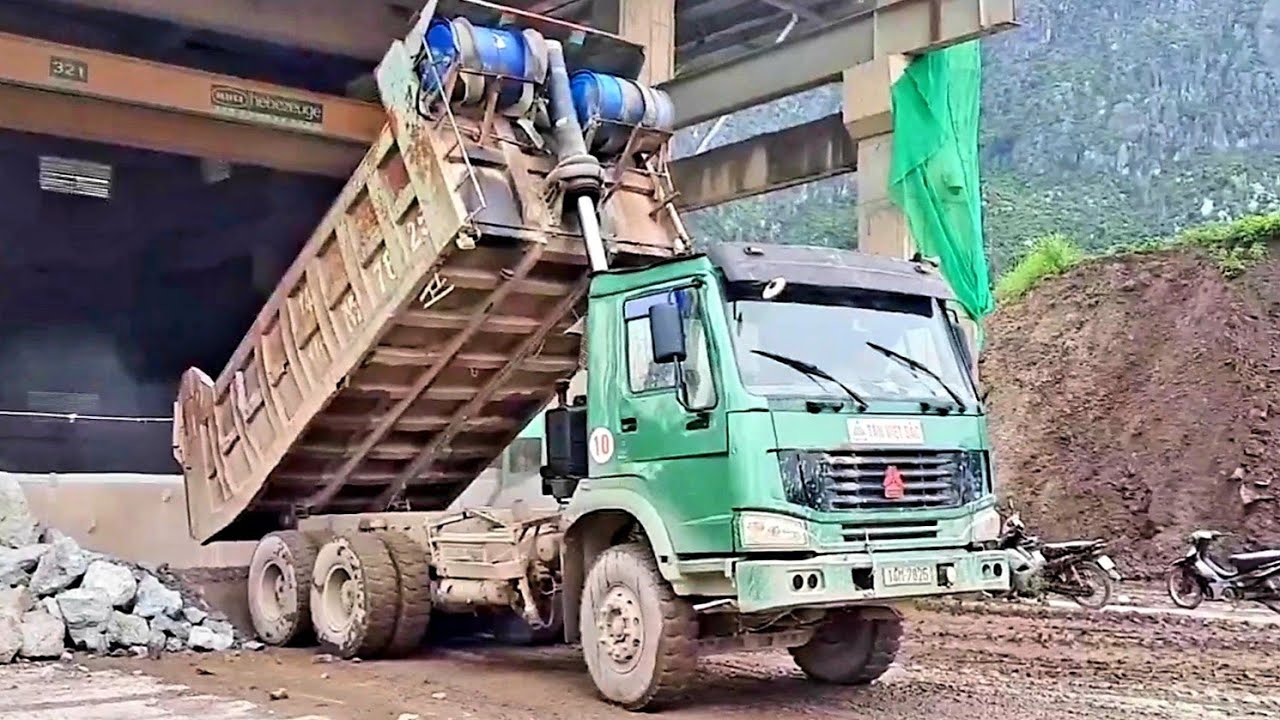 Forklifts and trucks working on the construction site