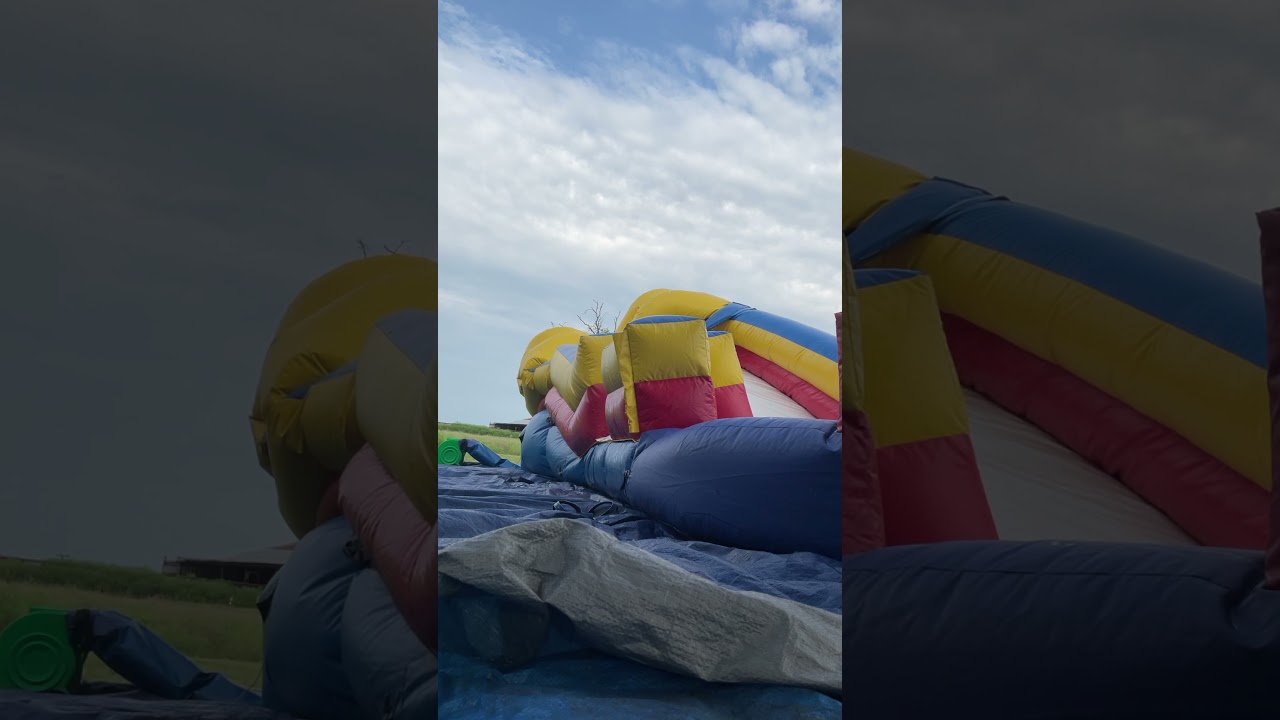 Bouncing on deflating inflatable bounce house slide