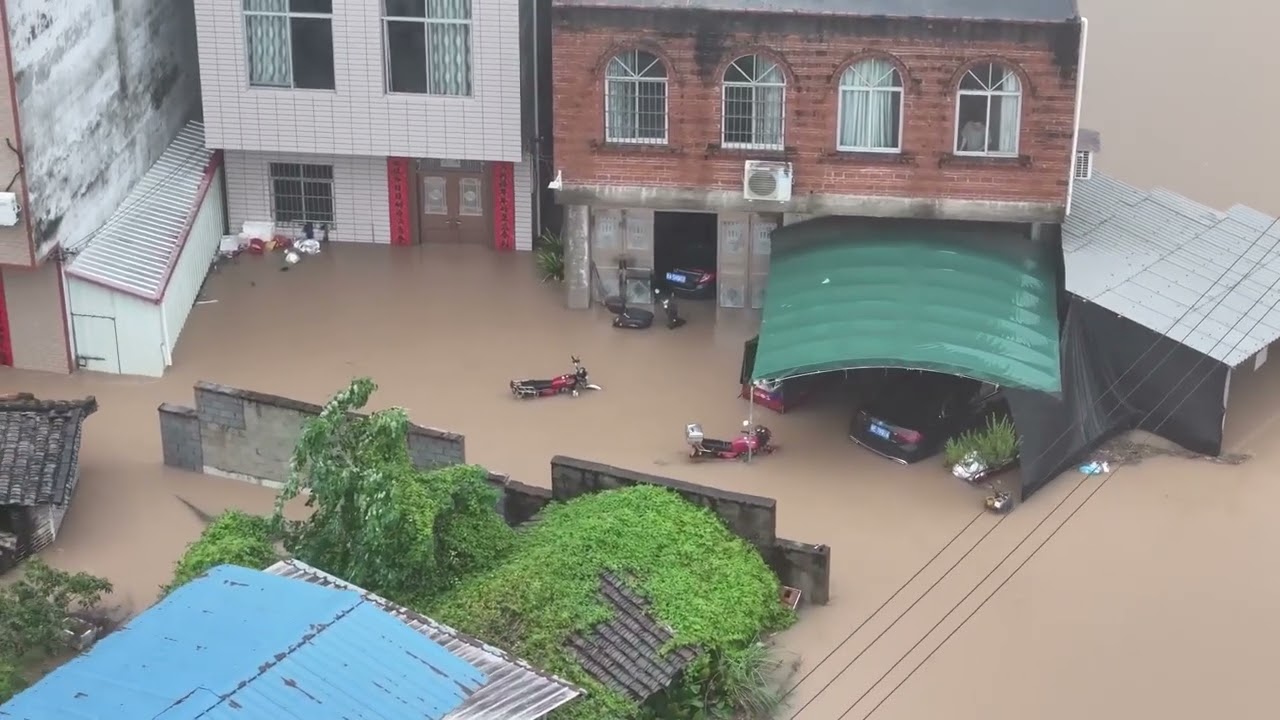 Brown floodwater roars through damaged dam after China's Guangxi hit by heavy rain