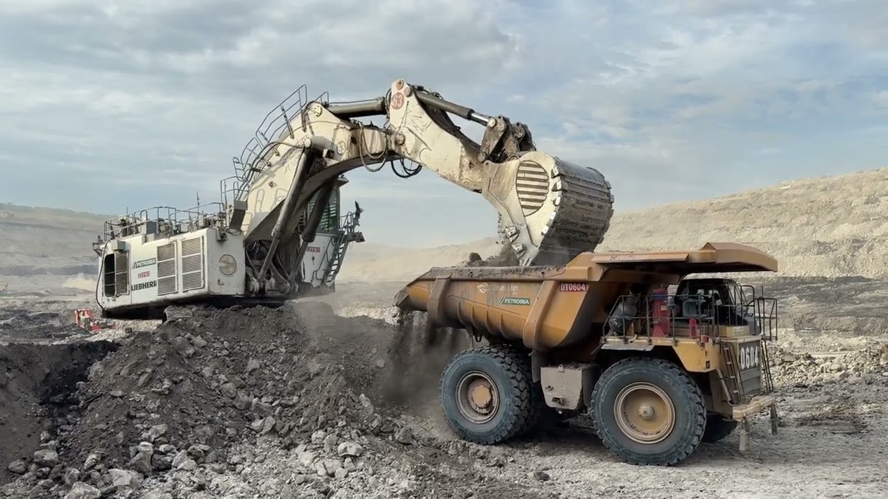 Big mining excavator Liebherr’s R9350 Loading caterpillar 777E dumper - miningstory