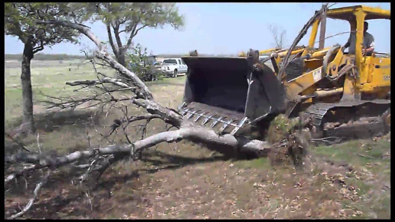 John Deere 555G Track Loader Taking Out Trees