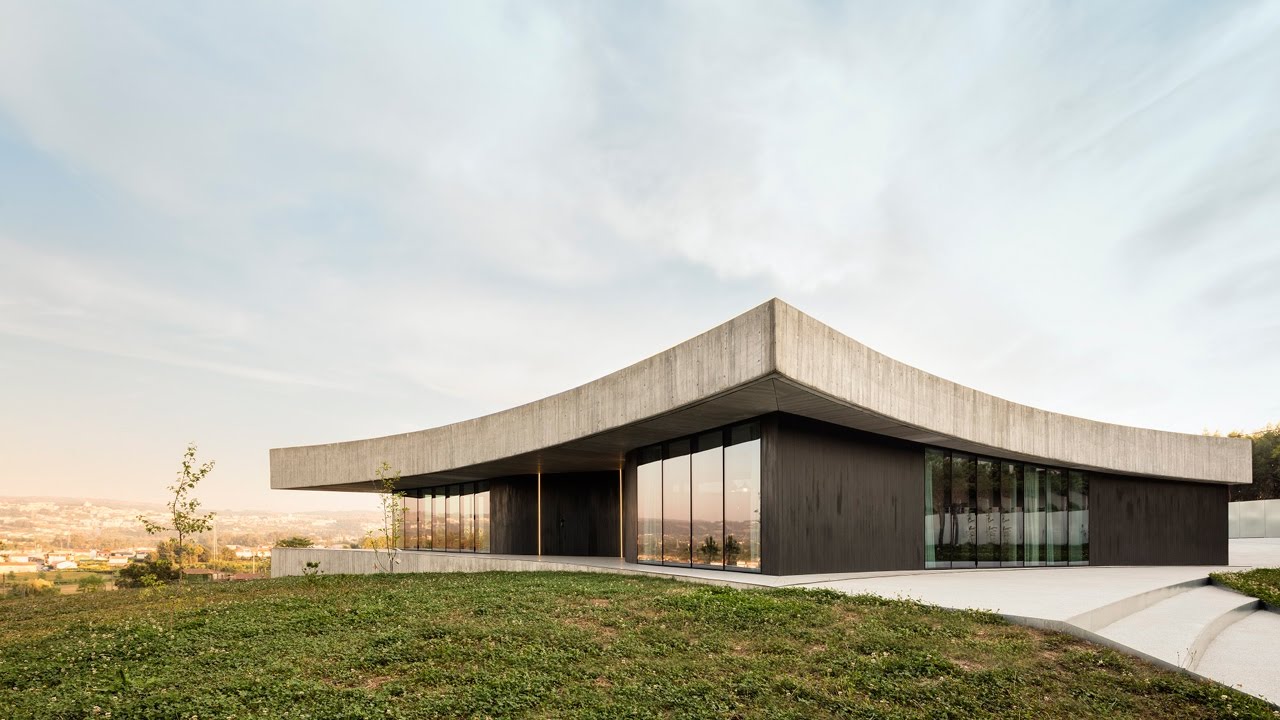 Spaceworkers curves concrete roof and glass walls for Cabo de Vila in Portugal