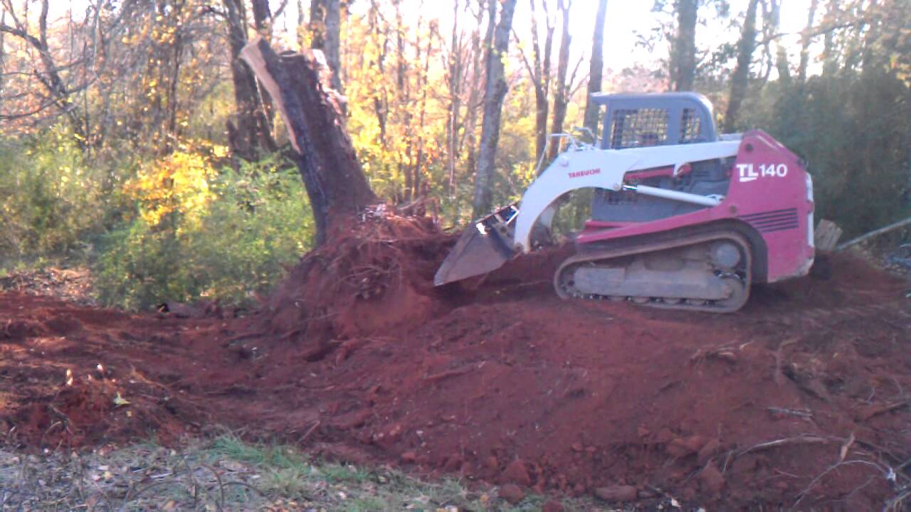 Takeuchi tl 140 pushing up a large stump