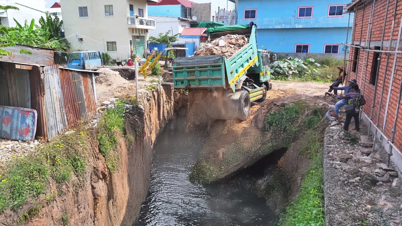 The project! Flooded Making Foundation Bulldozer Pushing the ground into a deep PIT black water
