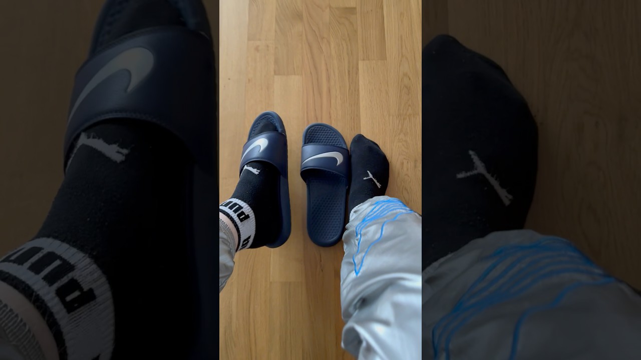 Blue Nike Flip Flops with black Puma socks and silver Adidas Nylon Pants