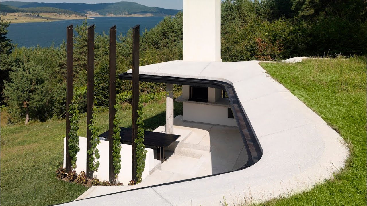 One half of the house built into the hillside and the other rising above ground in an insulated