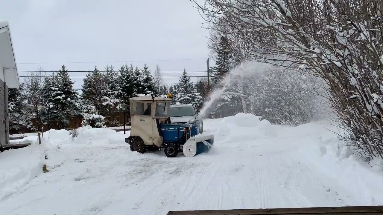 A tractor removes snow piles made by Case446 snow pusher #snowremoval #snowremovalequipment #snow 
