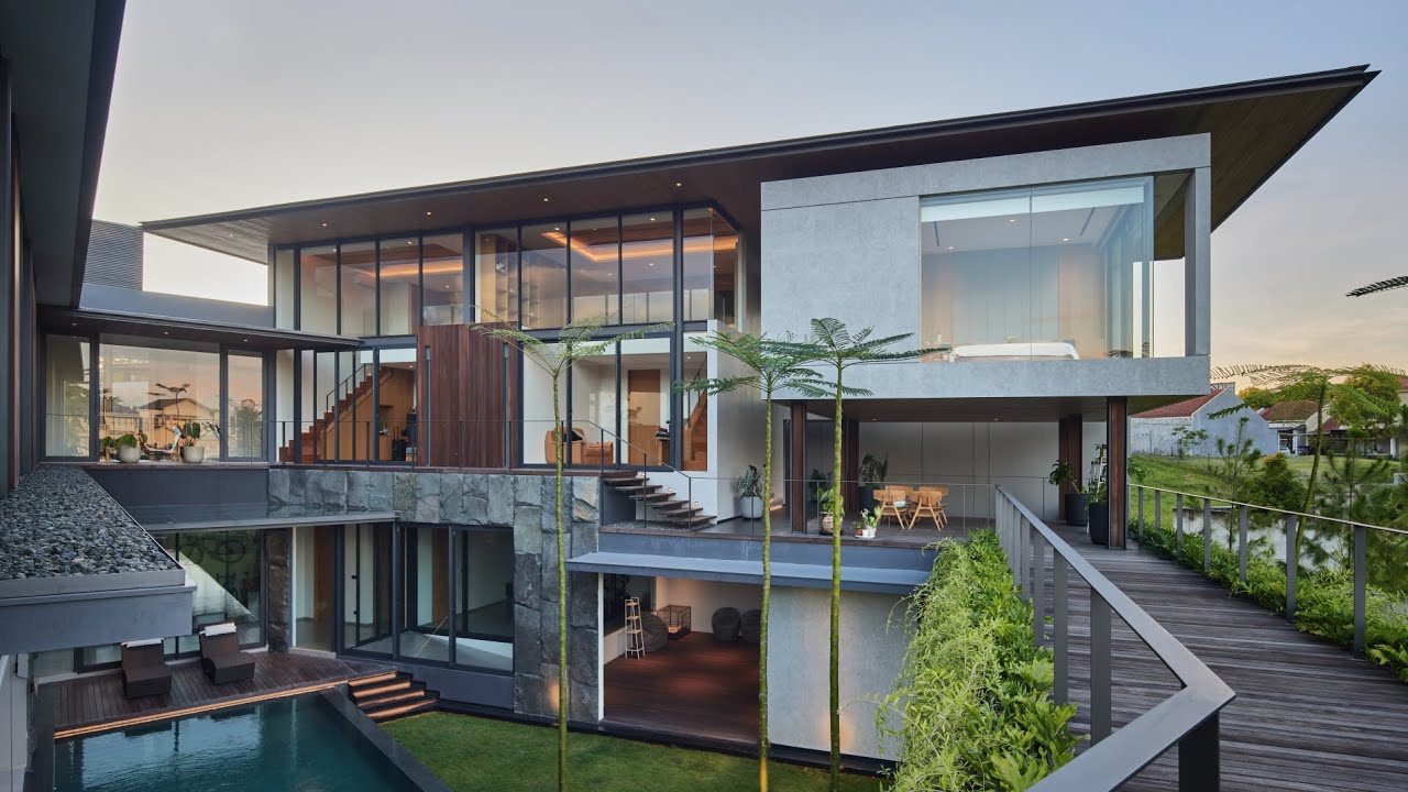 ETC 2.0 House. Tropical Modern House in irregular site with Rice Field and Lake View by RAKTA STUDIO