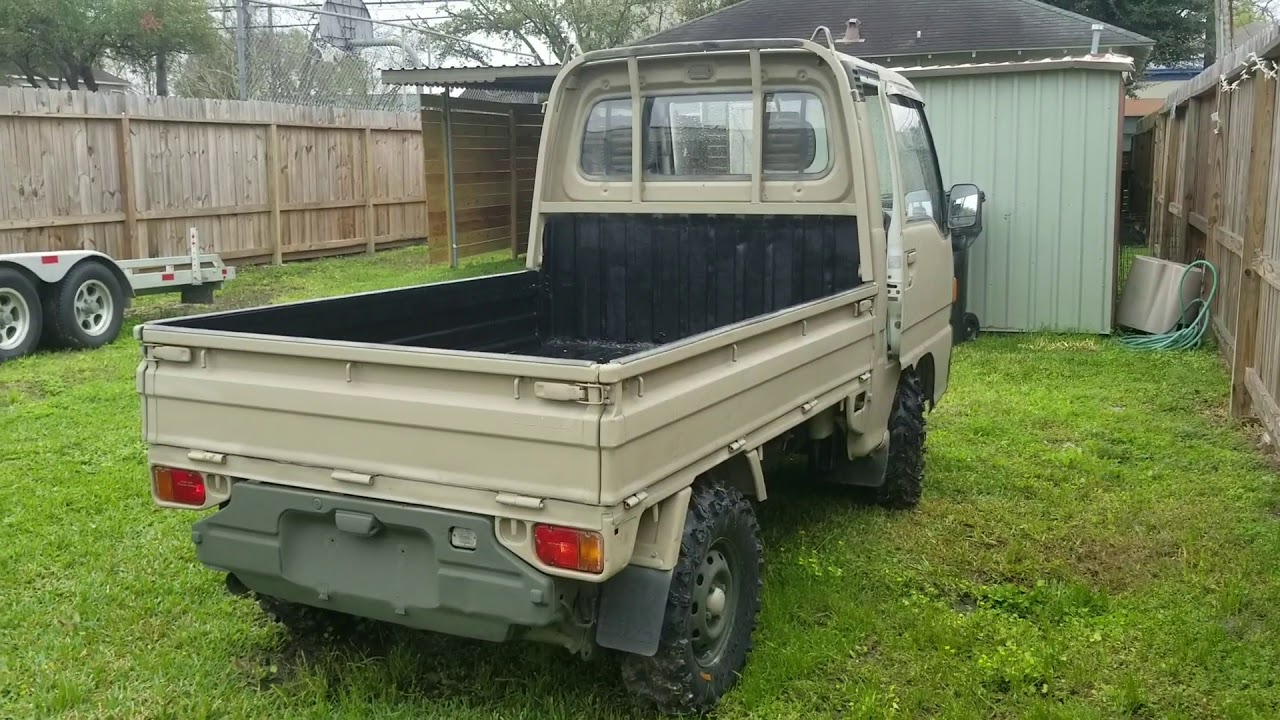 Custom Subaru Sambar walkaround, khaki camo with big tires.