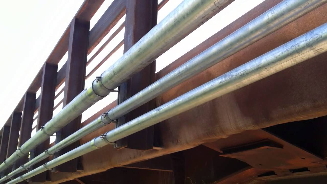 Installing utility pipes on bridge with uni-struts