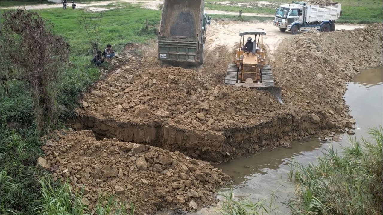 Small Bulldozer Pushing Rock And Soil Built Small Road With 5T Dump Trucks