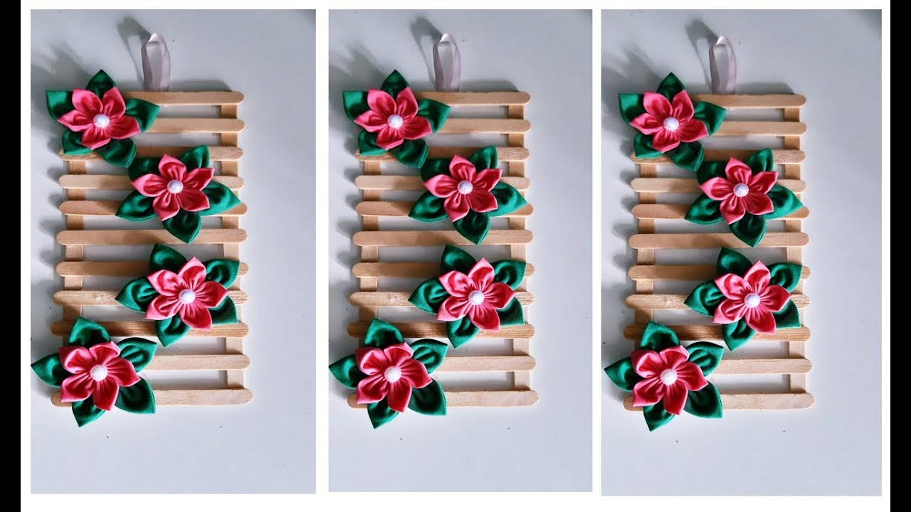 ARRANJO PARA PAREDE FEITO COM FLORES DE FUXICOS E PALITO