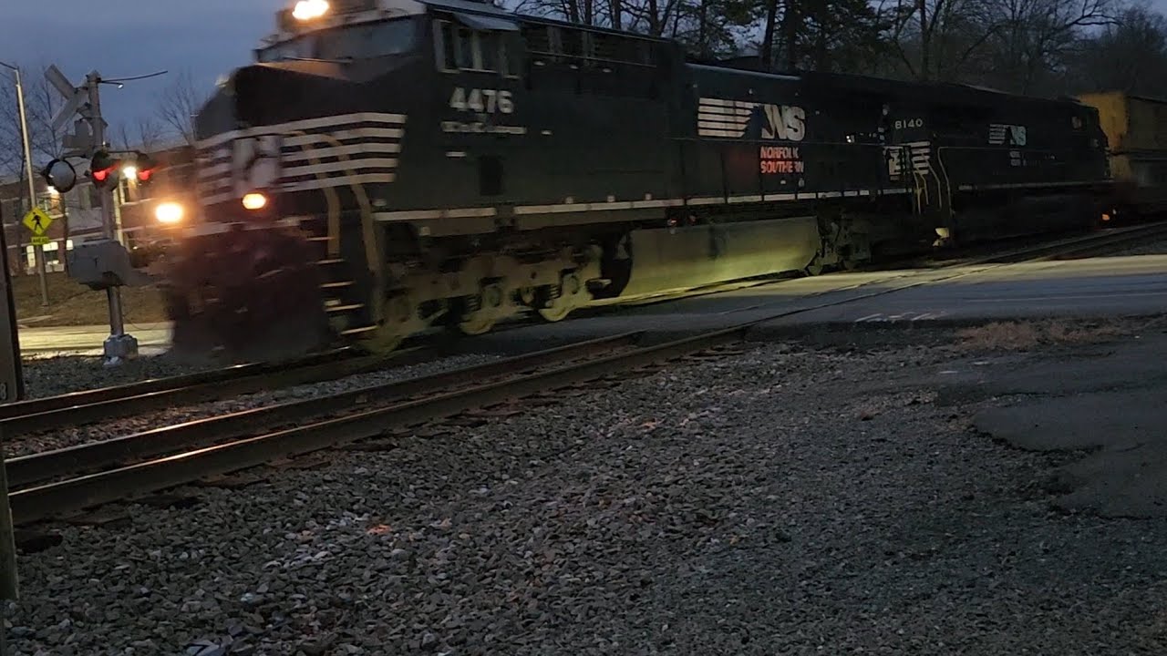 NS AC44C6M 4476 leads NS 289 racing Amtrak ALC-42 307.