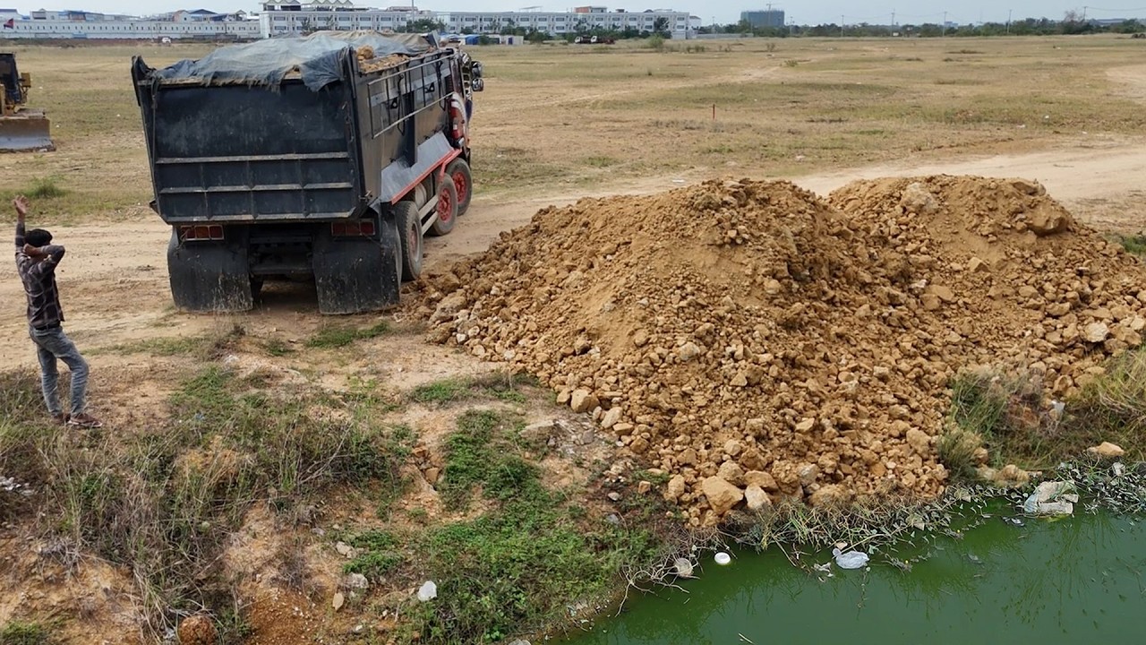 Interesting, Show Start landfill using 25.5ton trucks Drop soil & push filling by KomatSu Bulldozer