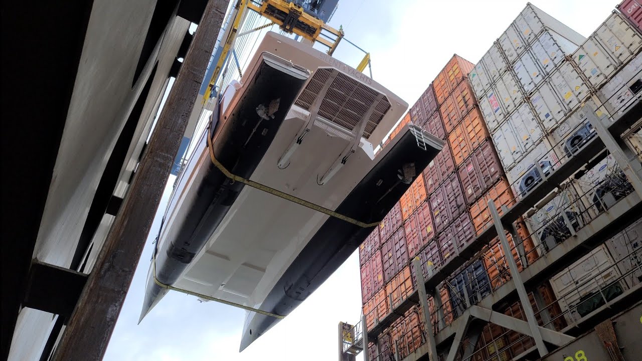 SILENT YACHTS SOLKRAFT CATAMARAN HOISTED THROUGH THE AIR - LANDS IN WATER