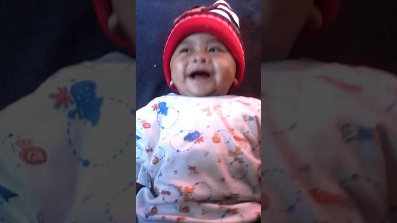 Laughing a cute baby with a shocked face