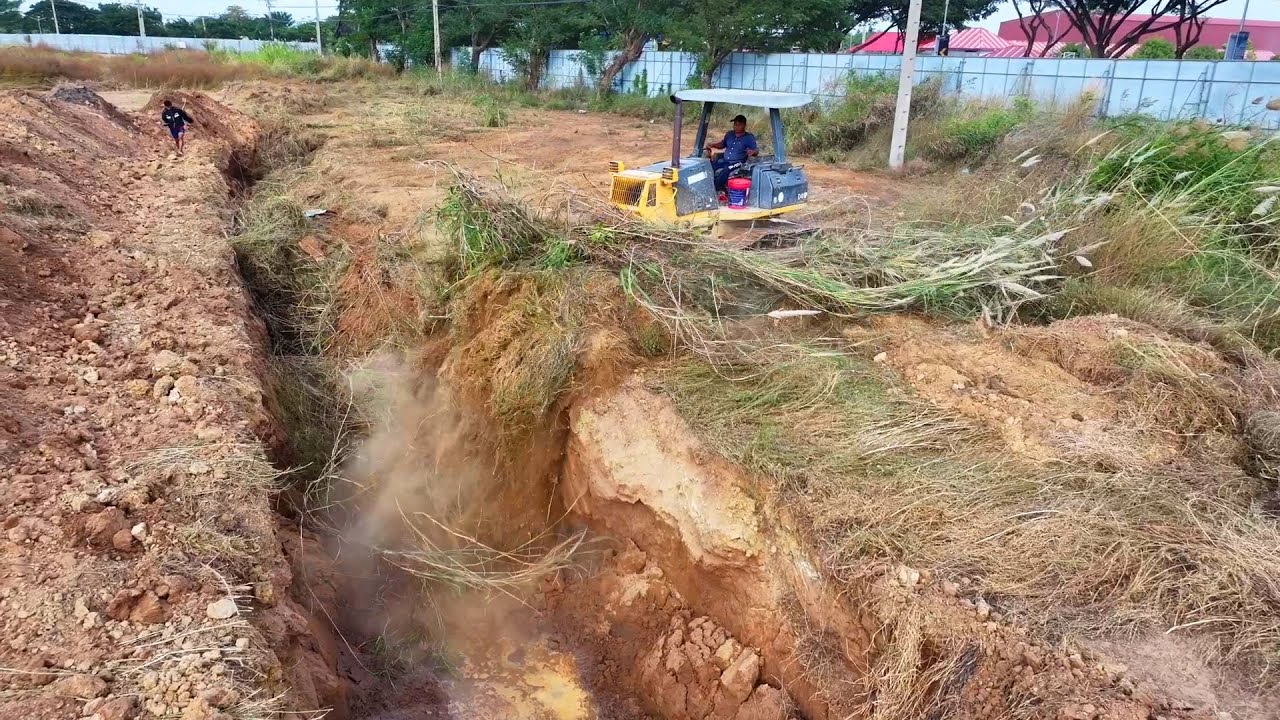 WONDERFUL.OPERATED OF FILLING FLOODED LAND NEXT TO THE ROADS USE SHANTUI DOZER AND SMALL DUMP TRUCKS