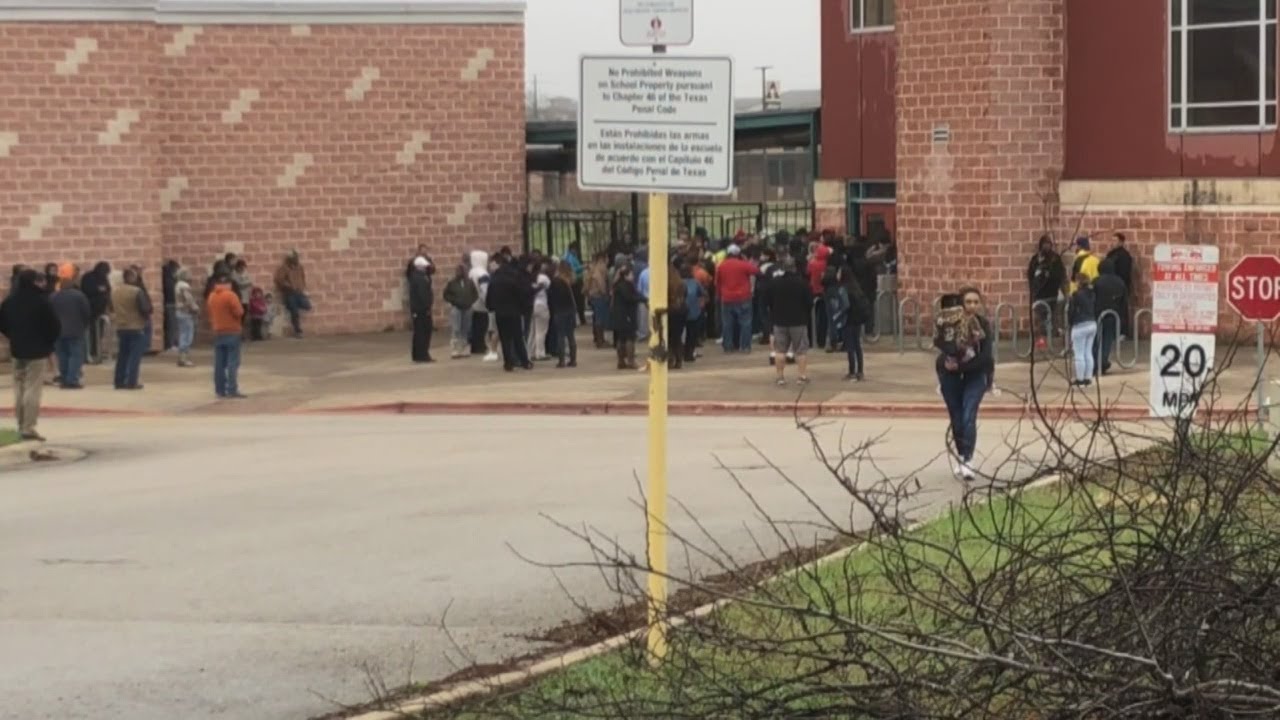 Parents waiting outside Akins High School during a lockdown at the school
