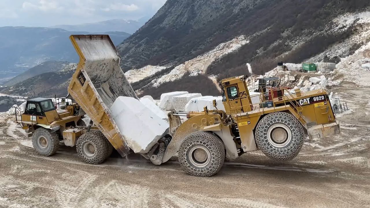 Caterpillar 992D Wheel Loader Loading Huge Marble Blocks On Caterpillar 775E Dumper