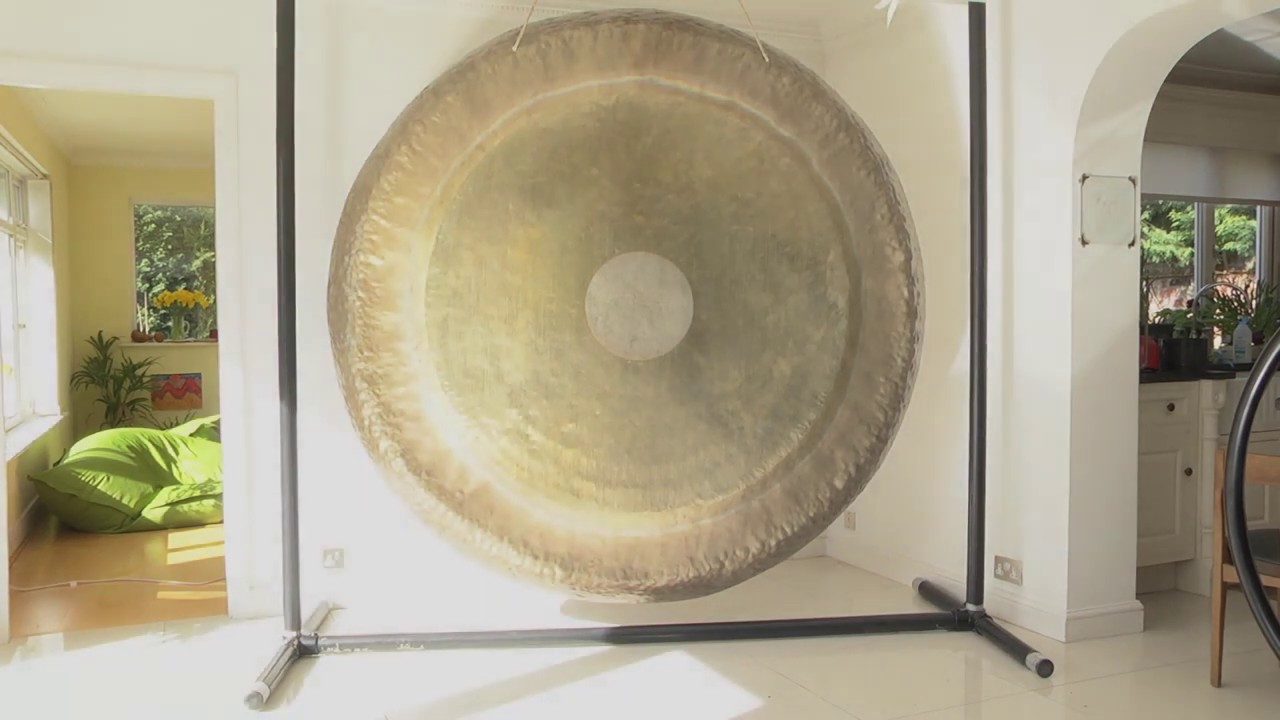 Hammer marks and surface texture of the Giant Golden Gong caught in partial sunlight.