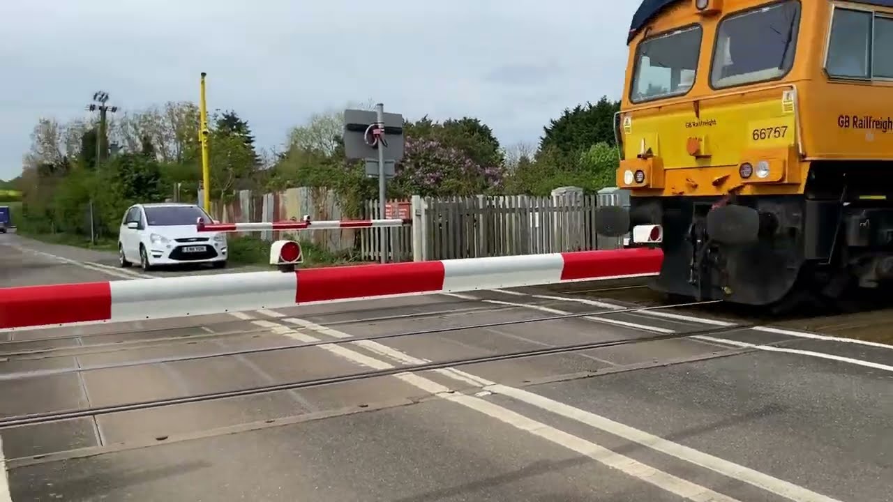 Trains at Baylham Farm level crossing, Needham Market - April 2024