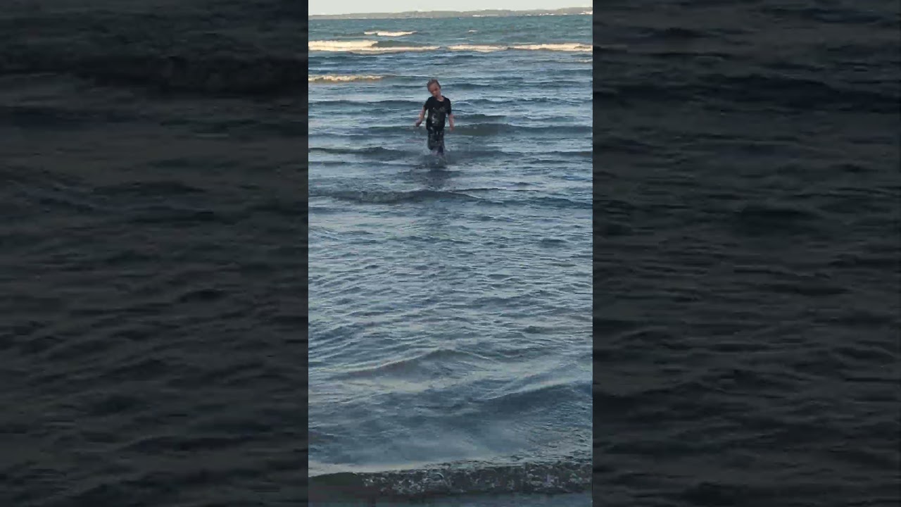 Sam swimming fully clothed in lake Erie