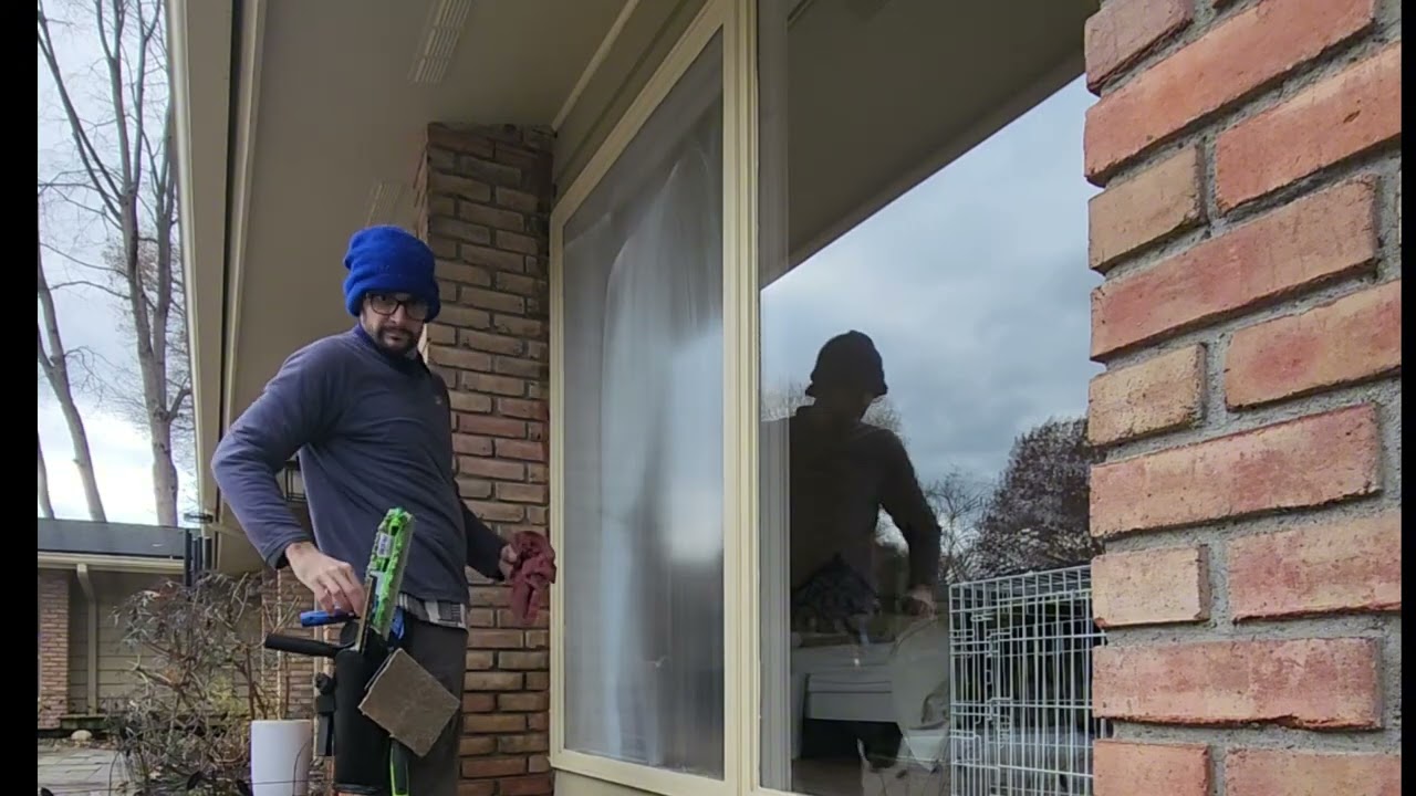 Exterior window cleaning on another slightly to tall window 