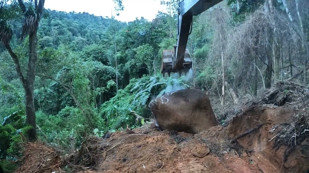 Escavadeira tirando pedras gigantes