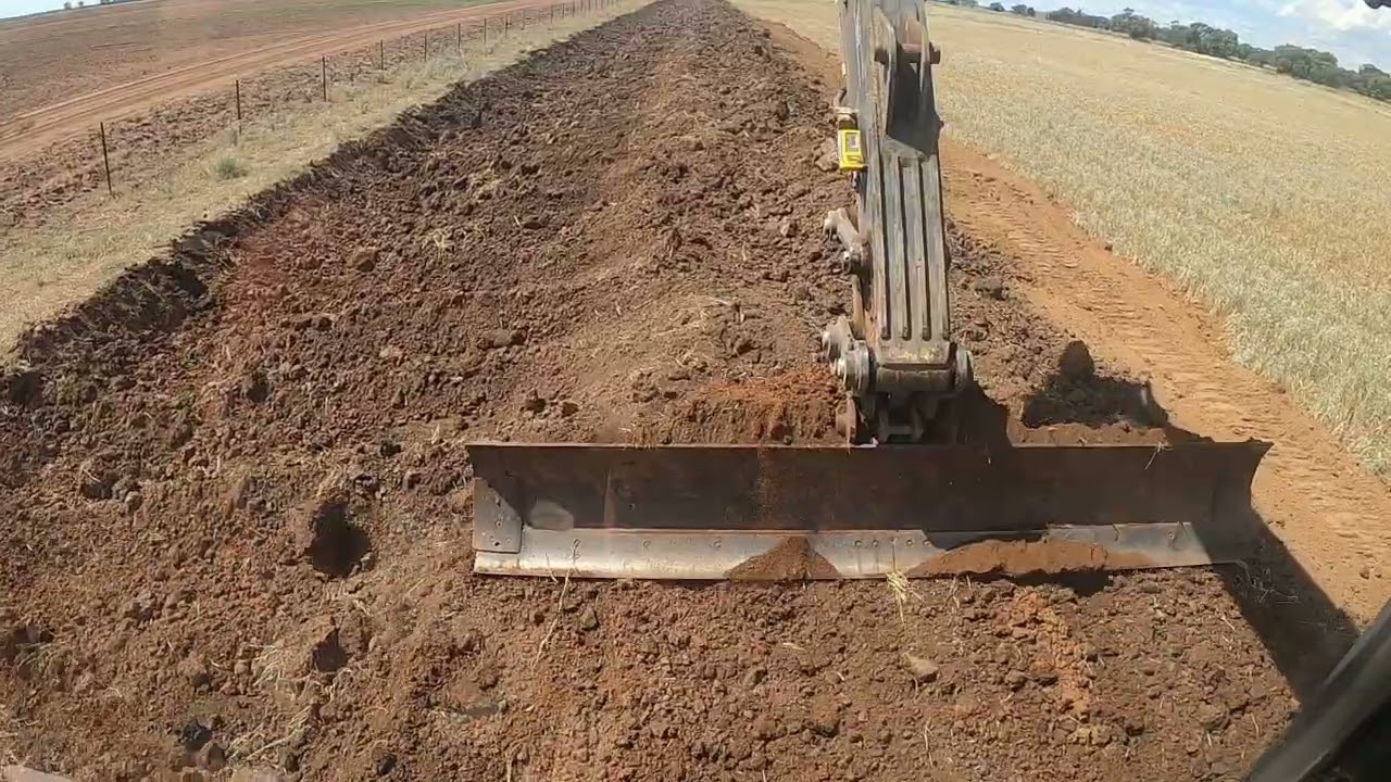 404.12ft grader blade attachment working on Volvo excavator building drainage ditch