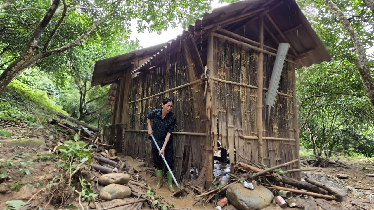 Single mother works to repair damage caused by heavy rains and flooding.