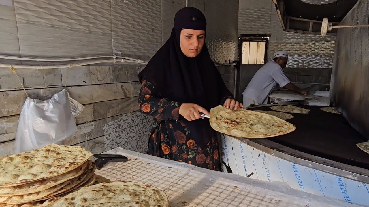 Earning money by a woman baking bread in a bakery