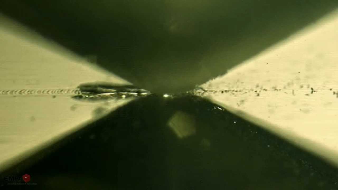 Optical In-Situ Scratch on a Diamond-like Carbon (DLC) Coating