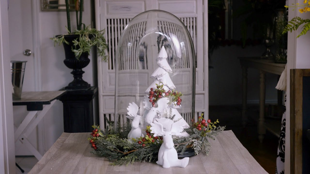 A Christmas-themed glass dome floristry design