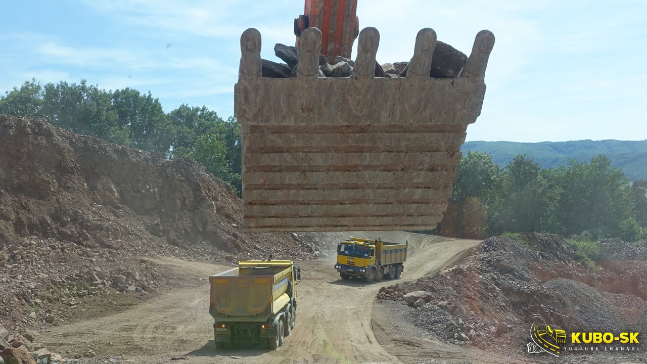 Doosan DX420LC loading dump trucks - excavator cab view