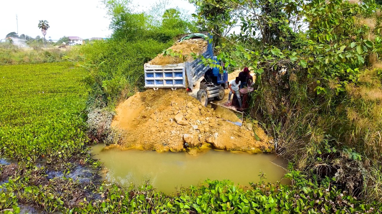 Build the new road in the lake by BULLDOZER AND DUMP TRUCK