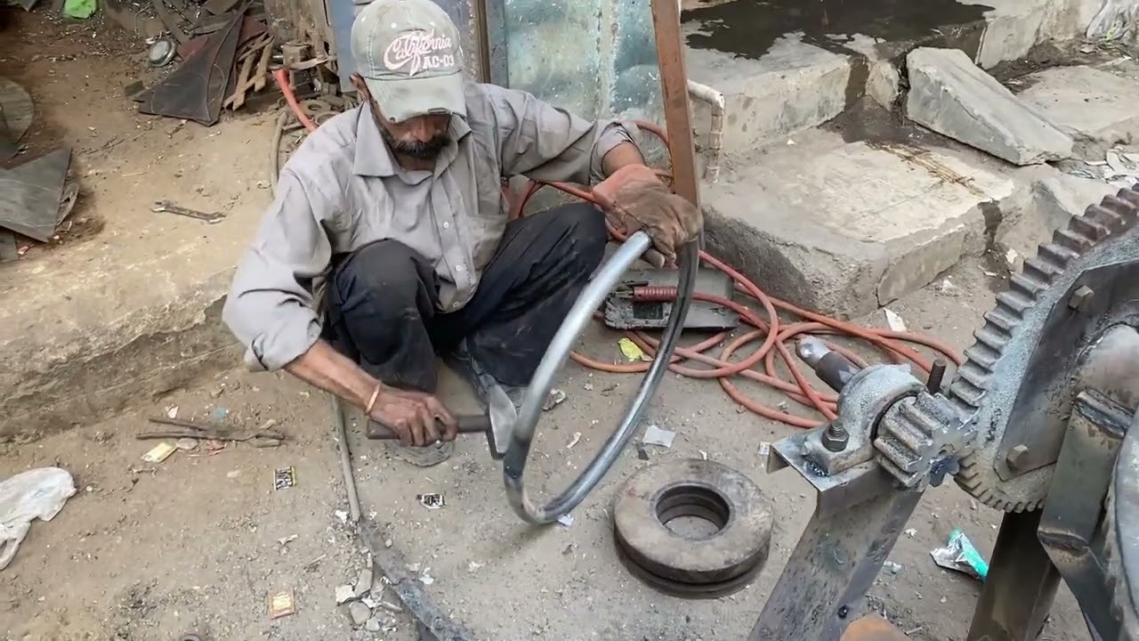 Today this worker makes a handle for a concrete mixer