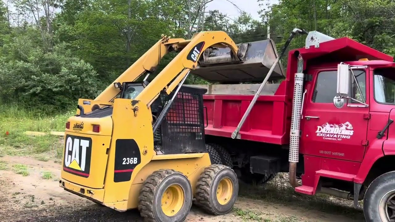 Grading a driveway with a CAT 236b skidsteer and the piggy bank!
