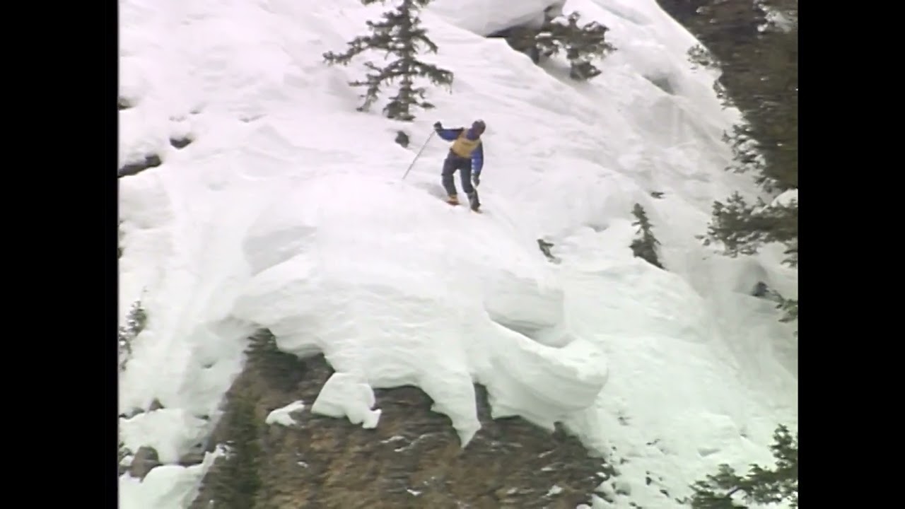 Skier Contemplates Jumping Off Cliff and Jumps