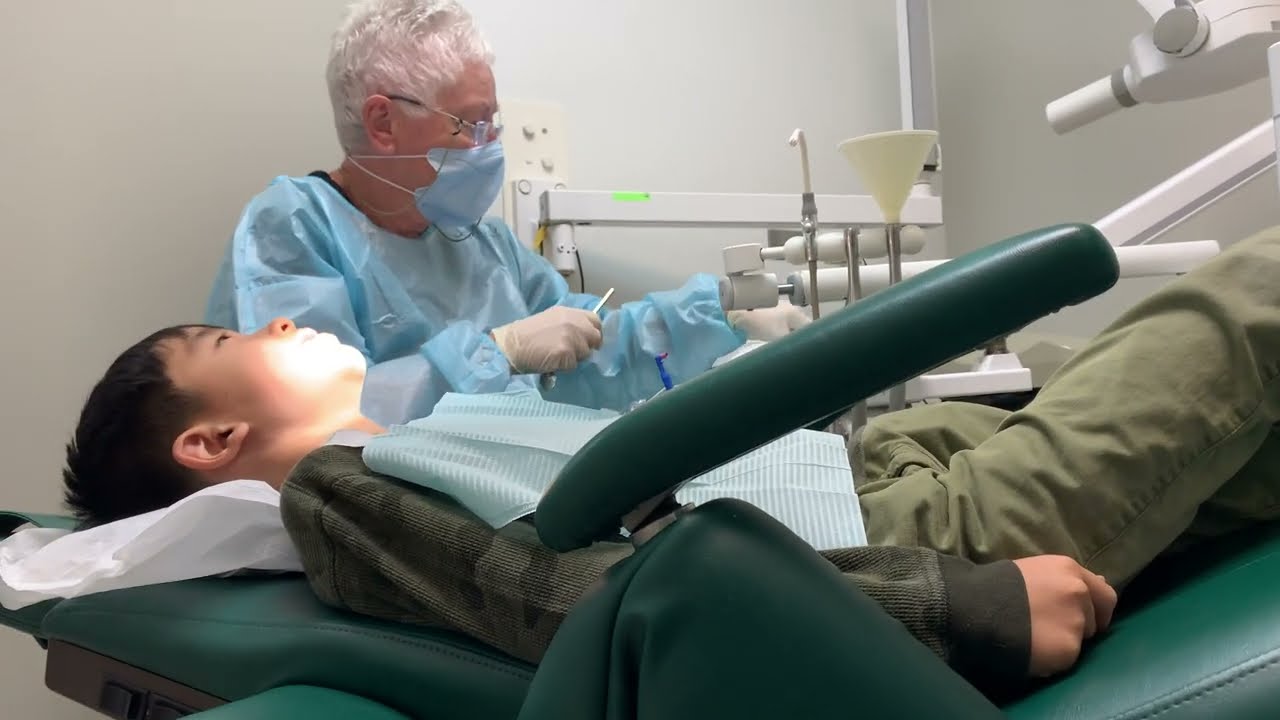 10 Year Old Getting Teeth Cleaned by Dental Hygienist during Dentist Visit