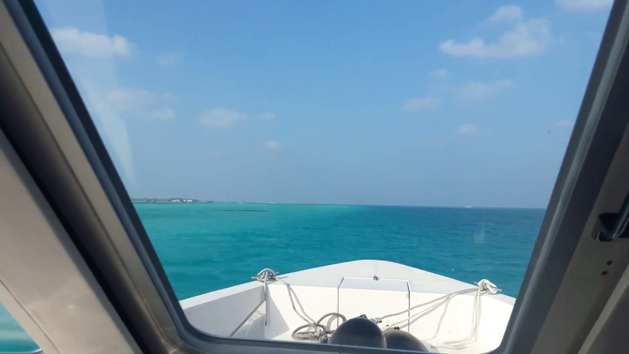 Leaving Thulusdhoo Island, Maldives by speed boat Coral Reef Express