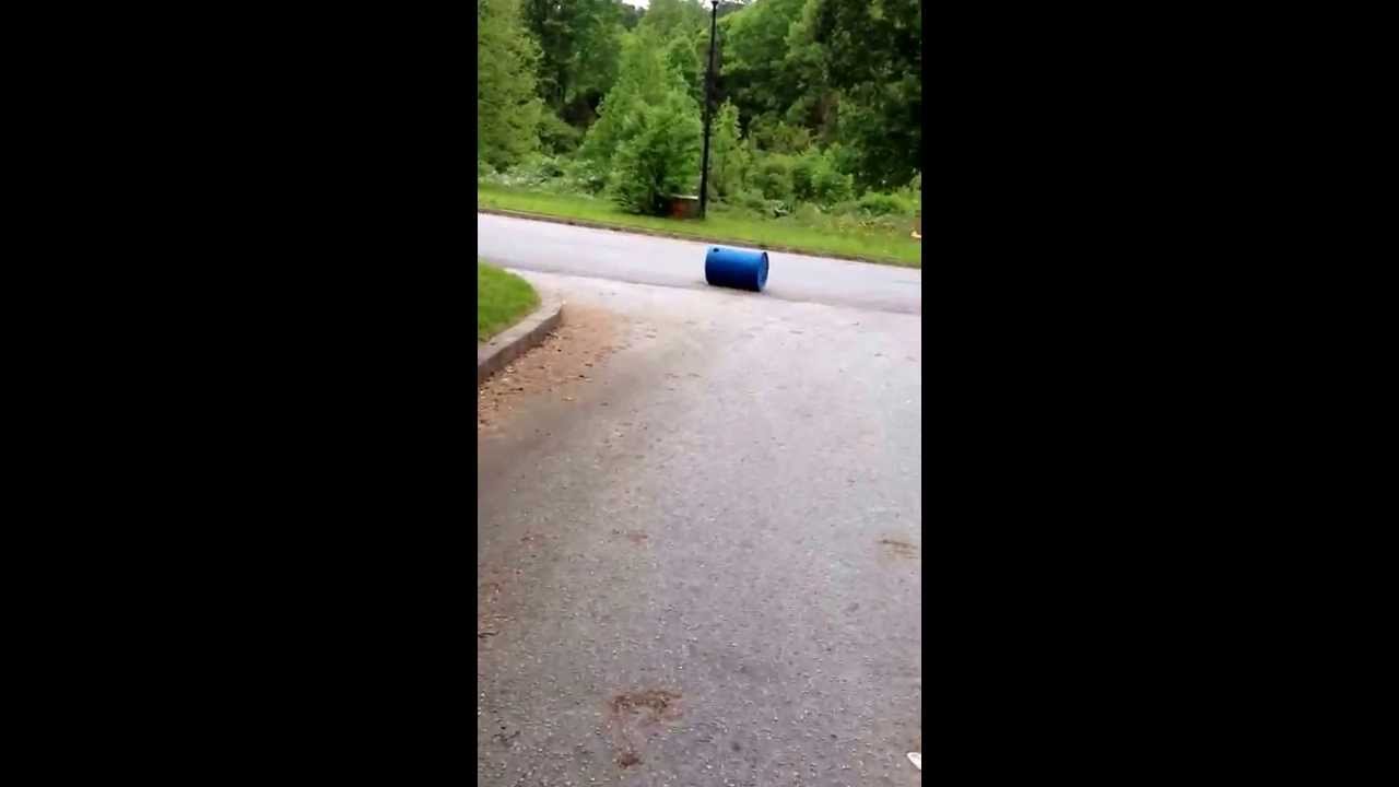 Rolling a person down a hill in a barrel